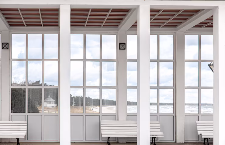 Exterior white building with benches overlooking sea 169016 19924